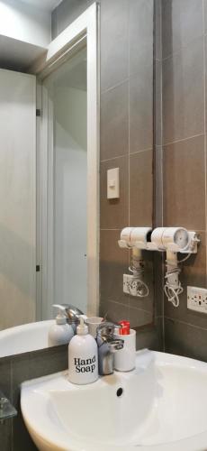 a bathroom with a sink and a mirror at Elite Pod at Knightsbridge Residences Makati in Manila