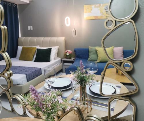 a living room with a couch and a table with a mirror at Elite Pod at Knightsbridge Residences Makati in Manila