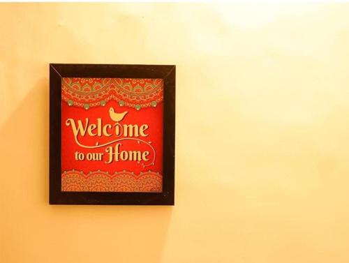 a picture of a welcome to our home on a wall at Exotic Stays I The Pine Trails I Serviced Apartments I Toy Train View I Best Seller I Guaranteed Best Price I Kasauli in Kasauli