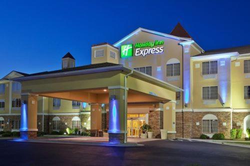 a hotel with a fire exit sign in front of it at Holiday Inn Express Savannah Airport by IHG in Savannah