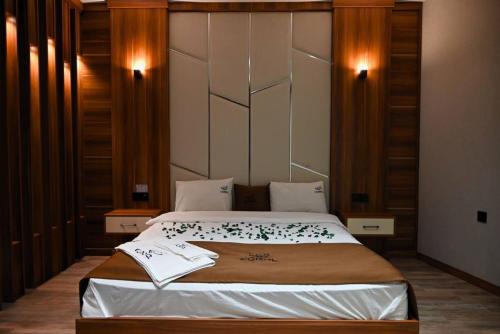 a bedroom with a large bed in a room at Coral Hotel in Duhok