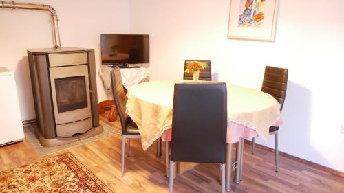 a dining room with a table and a fireplace at Lerchenhof in Friesach
