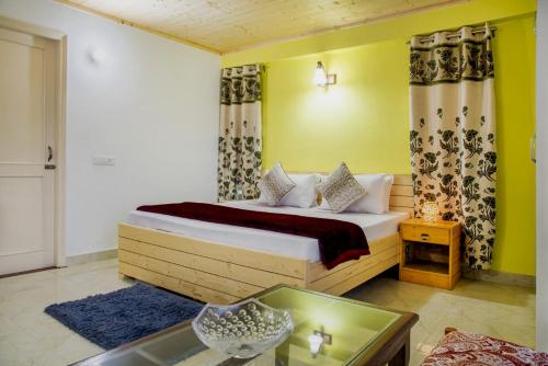 a bedroom with a bed in a room with yellow walls at Exotic Stays I The Kasauli Western Uphills I Vacations I Family Groups & Events I Forest Treks I Memories I Serviced Apartments I Kasauli in Kasauli