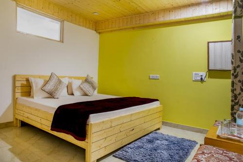 a bedroom with a bed in a room with green walls at Exotic Stays I The Kasauli Western Uphills I Vacations I Family Groups & Events I Forest Treks I Memories I Serviced Apartments I Kasauli in Kasauli