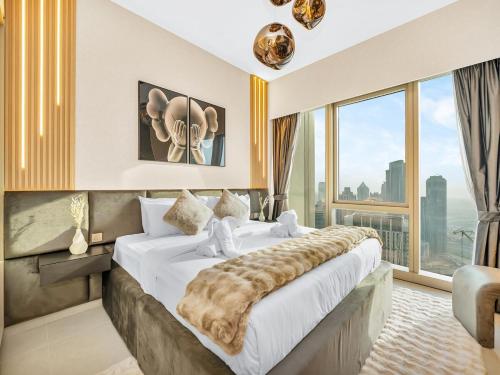 a bedroom with a large bed with a large window at 51st Floor Sea and Skyline Views LUXE 1BR in Dubai