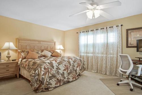 a bedroom with a bed and a ceiling fan at Hutchinson Island Resort-style Beachside Condo in Fort Pierce