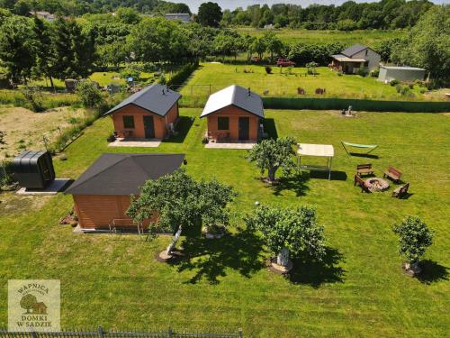 an aerial view of a farm with cottages in a field at Domki w sadzie Wapnica koło Międzyzdrojów in Wapnica