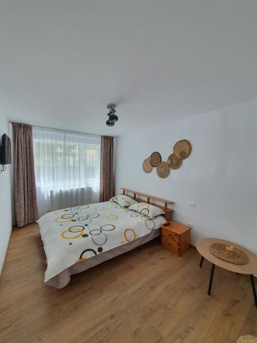 a bedroom with a bed and a table at BicazApart in Bicaz