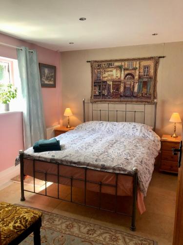 a bedroom with a bed with a painting on the wall at Rural retreat near Knock in Ballyhaunis