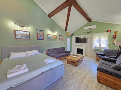 a bedroom with a bed and a living room at Luka's Family Comfort Apartment in Prčanj