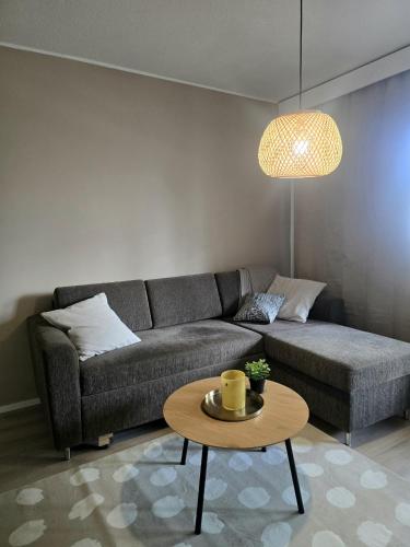 a living room with a couch and a table at Saunakaksio - cozy flat Pieksämäki in Pieksamaki