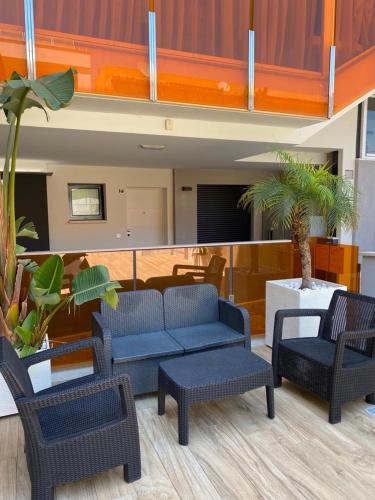 a lobby with a couch and chairs and a table at Amber Terrace - Torrevieja in Torrevieja
