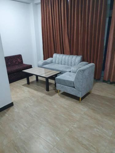 a living room with a couch and a coffee table at Revo guest house in Addis Ababa