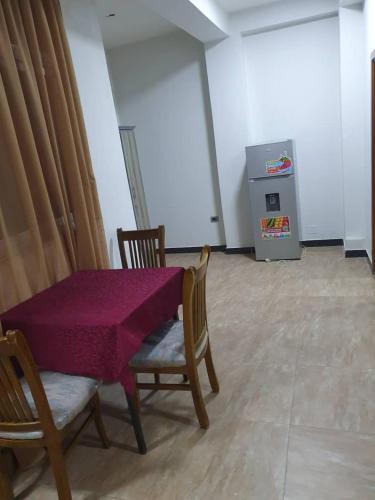 a table and chairs with a purple table cloth on it at Revo guest house in Addis Ababa