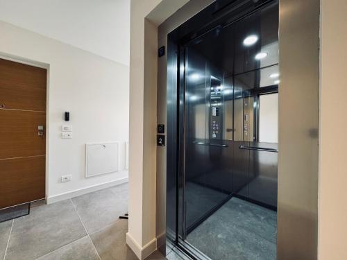 a glass walk in shower in a room at Residenza esclusiva appena costruita in Imola