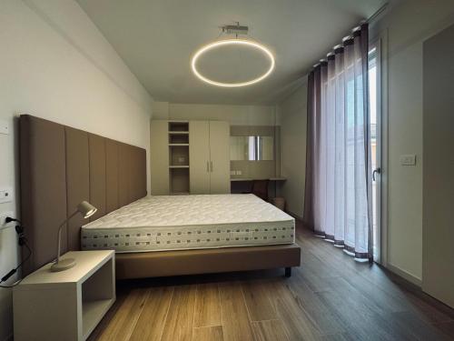 a bedroom with a bed and a large window at Residenza esclusiva appena costruita in Imola