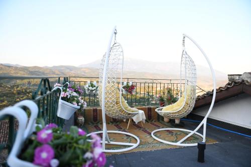 a balcony with chairs and a view of a mountain at Sokaku Monark in Berat