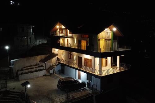 a car parked in front of a building at night at The Verra Homestay in Kulu