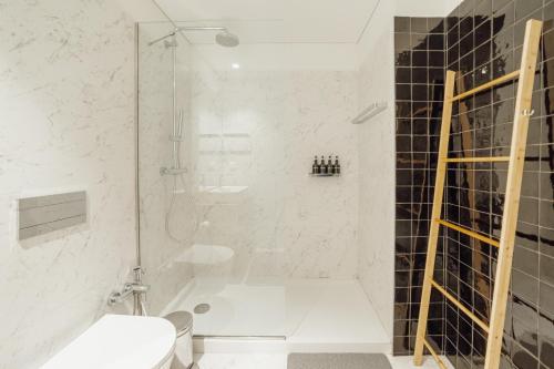a bathroom with a shower and a toilet at Beach & Sun Apartment by Vacationy in Bomfim