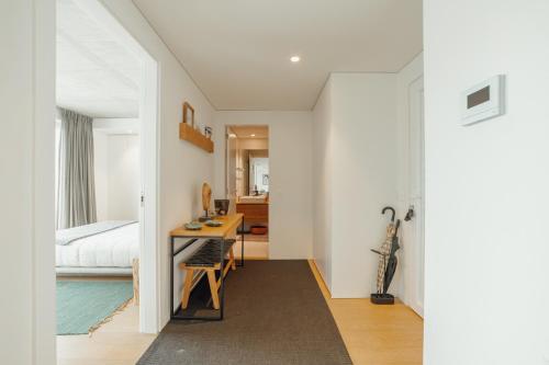 a bedroom with a bed and a desk in a room at Beach & Sun Apartment by Vacationy in Bomfim