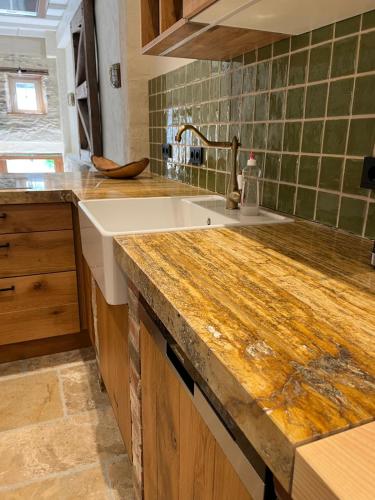 a kitchen with a sink and a counter top at Scheune Am alten Posthof Lieser in Lieser