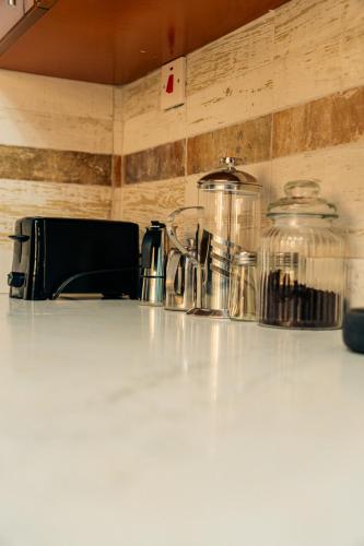 a counter top with two glass jars on it at 2,3 or 4 Bd townhouse overlooking Kingston in Kingston