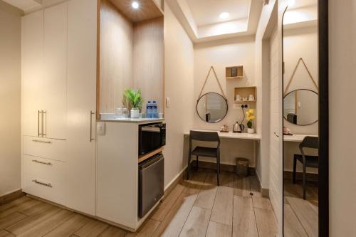 a small kitchen with a desk and a dining room at STAY Menlyn in Pretoria