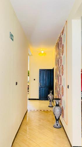 a hallway with two vases sitting on the floor at Beach House Douira in Agadir