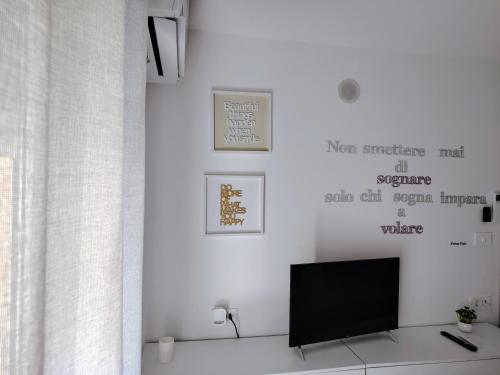 a living room with a tv on a white wall at Vivere in Slovenia in Plavje