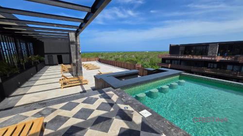 a swimming pool on the roof of a building at Hotel zone - Private Jacuzzi & Free Beach Club in Tulum