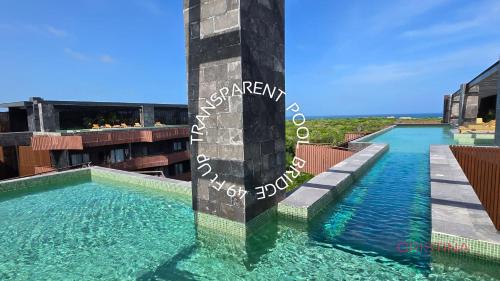 a swimming pool on the roof of a building at Hotel zone - Private Jacuzzi & Free Beach Club in Tulum