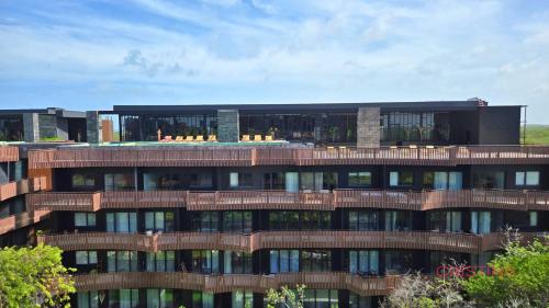 a tall building with a lot of windows at Hotel zone - Private Jacuzzi & Free Beach Club in Tulum