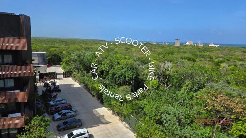 arial view of a parking lot with cars parked at Hotel zone - Private Jacuzzi & Free Beach Club in Tulum