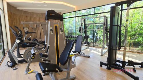 a gym with a bunch of exercise equipment in a room at Hotel zone - Private Jacuzzi & Free Beach Club in Tulum