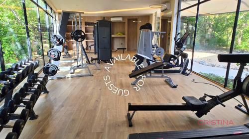 a gym with several treadmills and machines in it at Hotel zone - Private Jacuzzi & Free Beach Club in Tulum