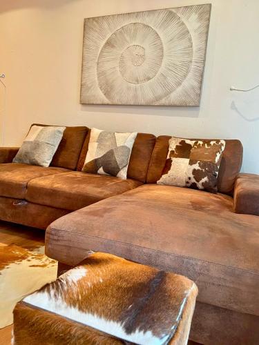 two brown leather couches in a living room at Laax Rancho Residence in Laax