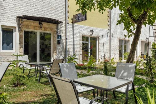 a group of tables and chairs in front of a building at *NEW IN 2025* - Hotel Subra Atrium in Herceg-Novi