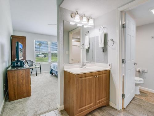 a bathroom with a sink and a mirror at Bayfront Kontiki 107 in Rockport