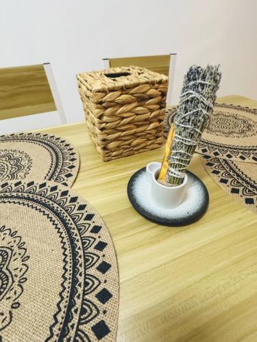 a mortar and pestle on a wooden floor with rugs at Mandala loft close to the beach in Haad Chao Phao