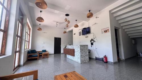 a living room with a couch and a table at J Terminal Hotel & Cafe in Barkot