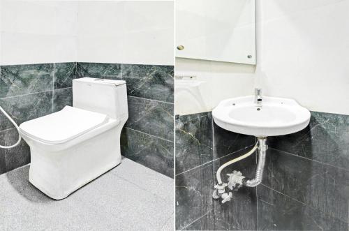 a bathroom with a toilet and a sink at Hotel O Mayur Inn in Surūrnagar