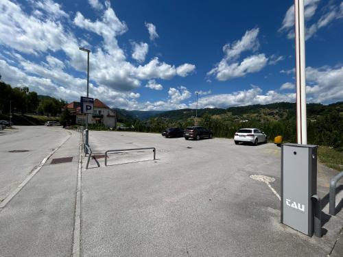 a parking lot with cars parked in front of a building at Bed & Breakfast Reaktiv in Zreče