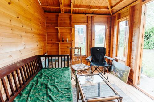 a screened in porch with chairs and a glass table at Lyndale House - North Norwich suburbs in Norwich