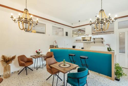 a kitchen with a blue bar and chairs at *NEW IN 2025* - Hotel Subra Atrium in Herceg-Novi