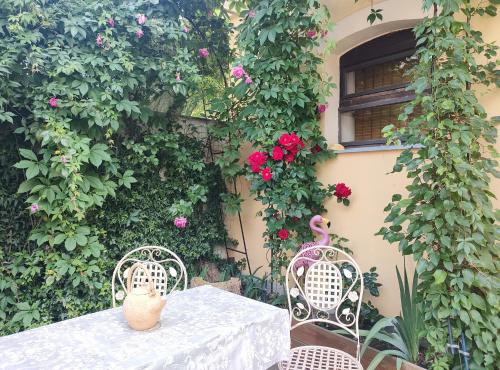 a table and two chairs with flowers on a wall at Ubytovani Sarka in Čistá