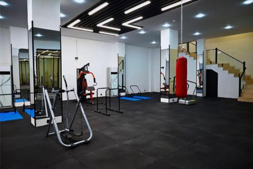 a gym with treadmills and equipment in a room at Coral Hotel in Duhok