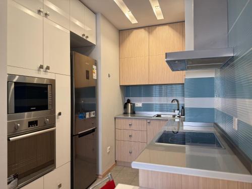 a kitchen with a sink and a stove top oven at Sweet Home Apart-Hotel in Yerevan