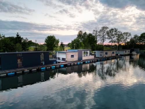 a group of houses on a dock in the water at The Creative Boat in Lithoijen