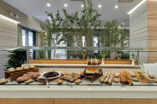 a buffet line with many different types of food at Sentido Kyknos Beach Adults Only in Malia