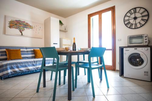a room with a table and chairs and a bed at Easylife - a 2 passi dal mare Sant'Isidoro in Sant'Isidoro